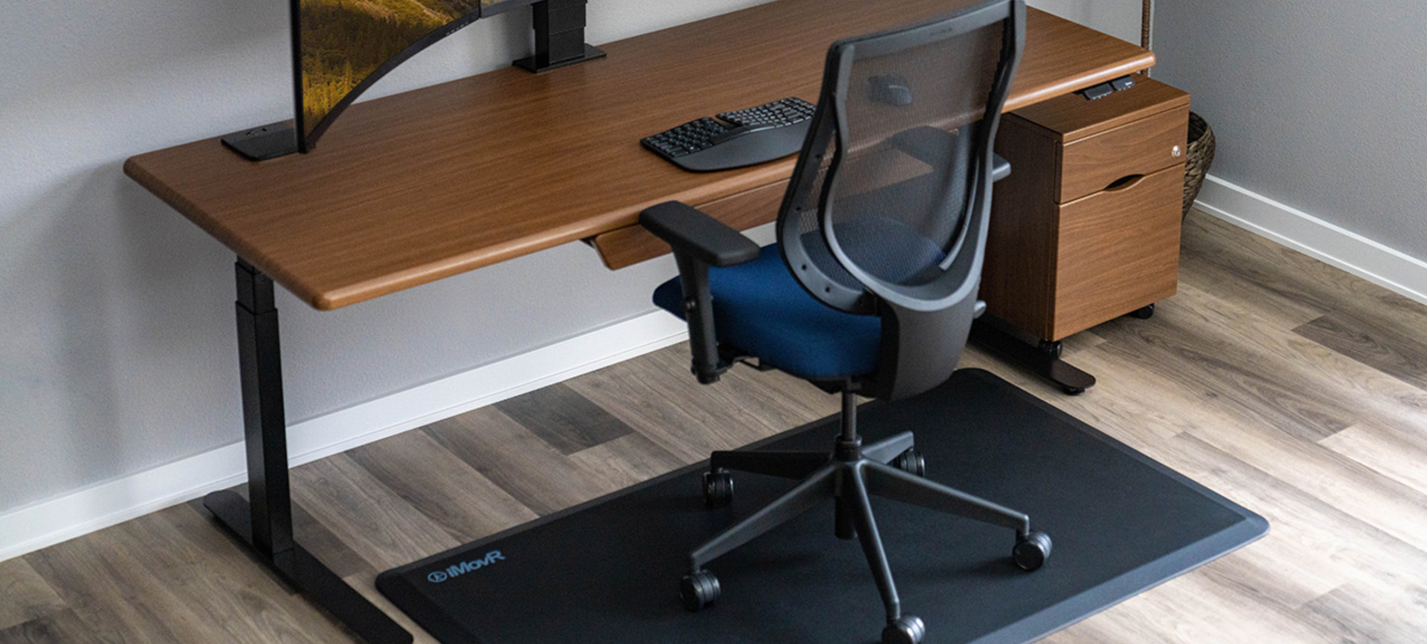 Lander Desk in Bella Walnut on Black Base, shown with optional Premium Drawer and Mobile File Cabinet