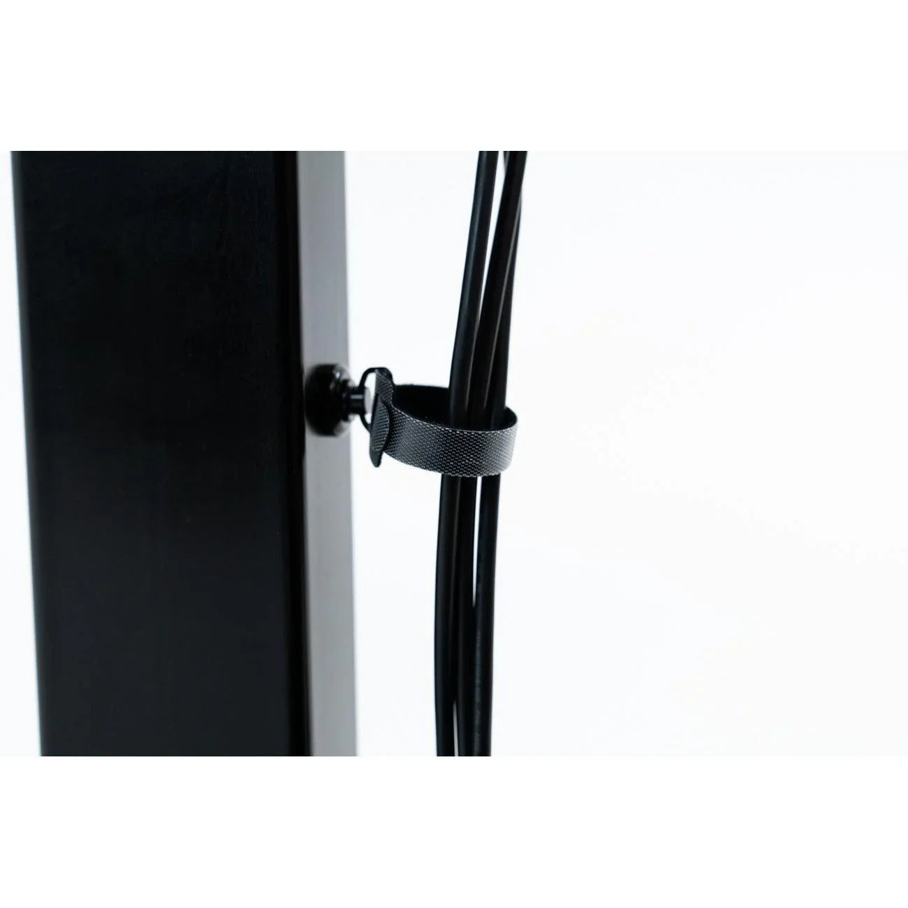 Tucker Cable Wrap Tie and Super Magnet Cable Mount holding cables on desk leg.