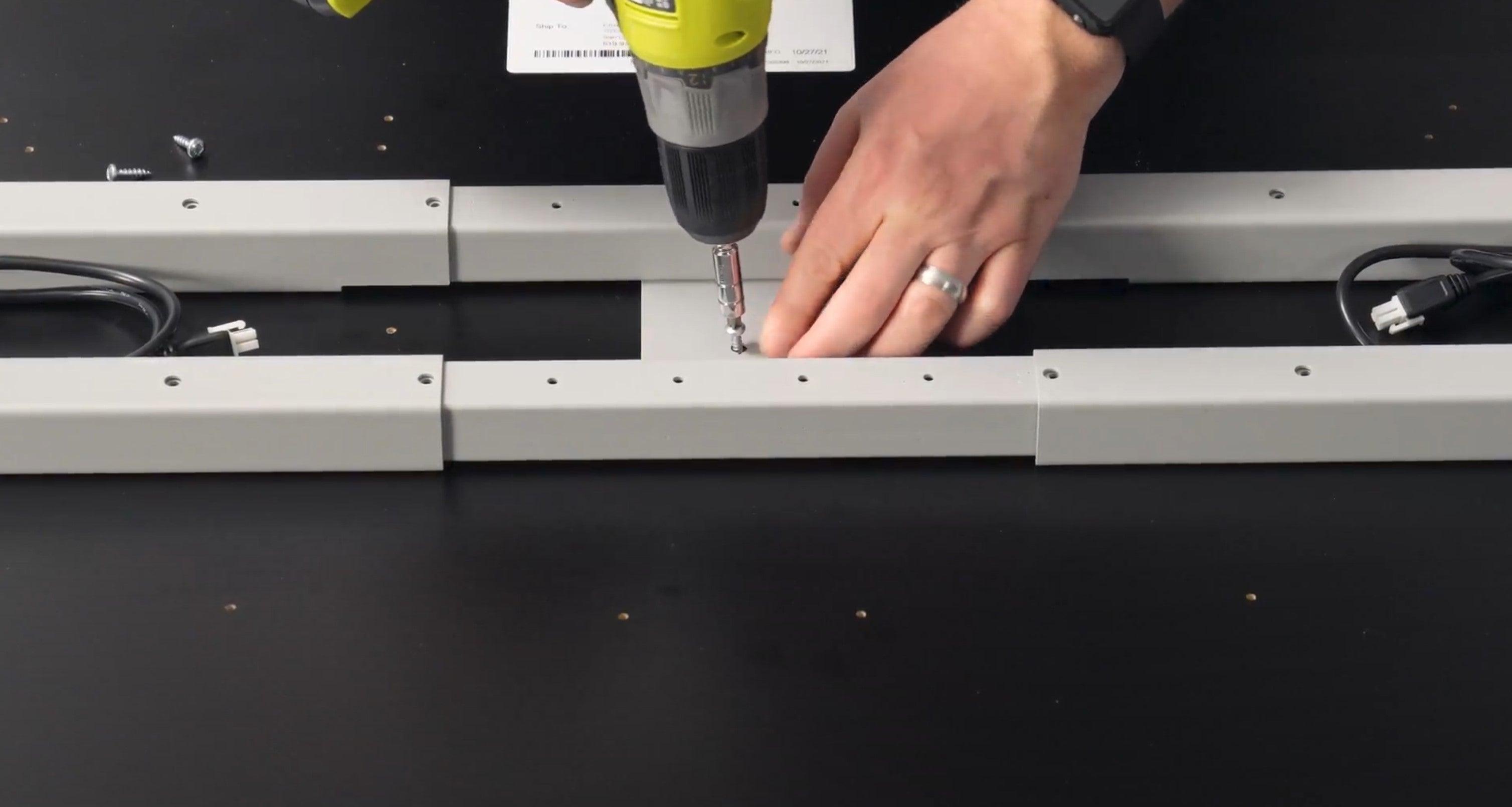 Assembling the Jaxson Standing Desk base to a desktop.
