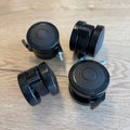Set of four black polyurethane locking caster wheels with threaded stems, designed for standing desks.