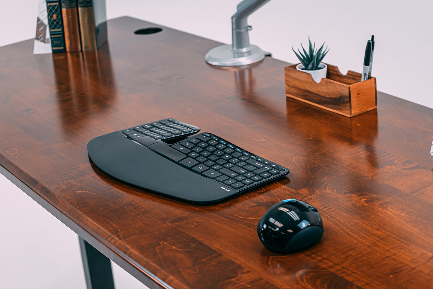 Solid Wood Lander L-Desk with Leather Maple finish on Black base.