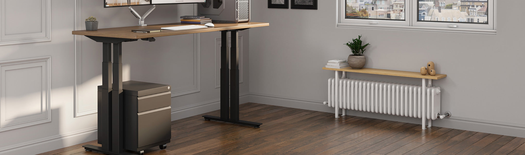 Modern office setup with a standing desk, computer, and radiator.