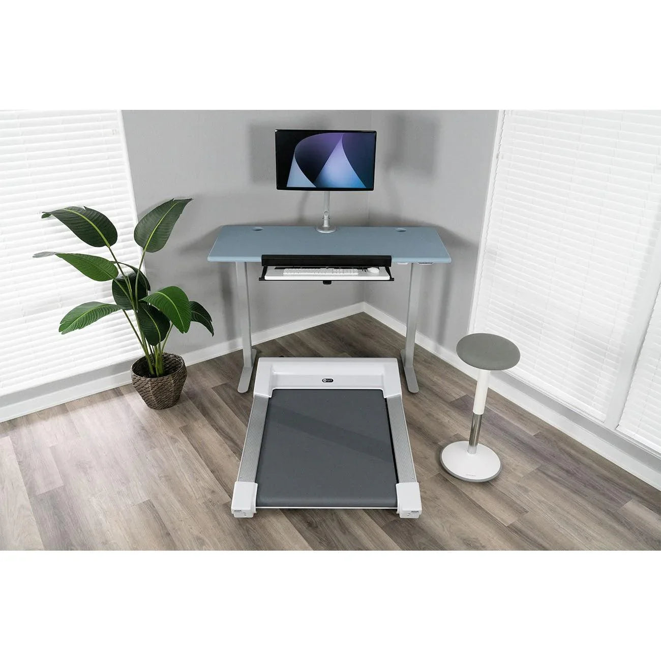 Energy Stool next to Lander Unsit Treadmill Desk, with SteadyType Exo Keyboard Tray