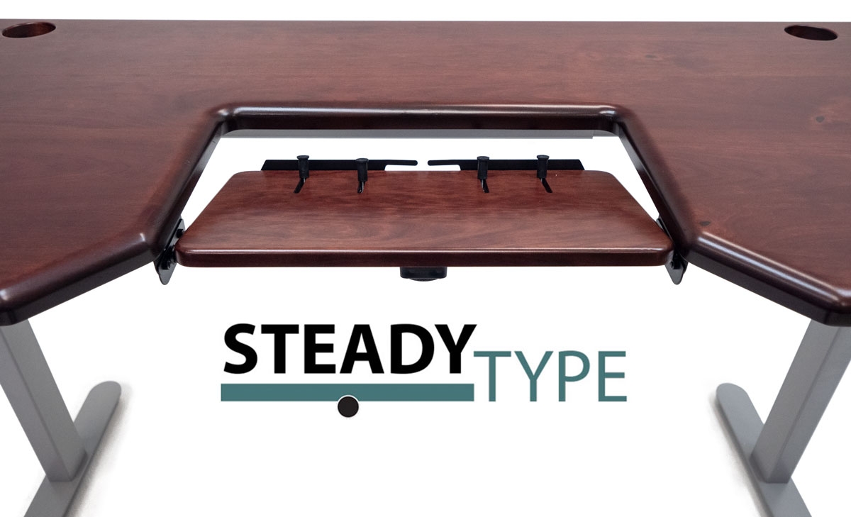 Built-in SteadyType Keyboard tray on Lander Desk with Caramel Walnut solid wood desktop on silver base